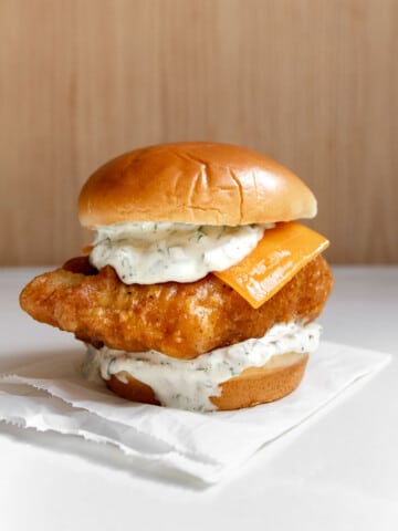 fried cod fish sandwich (homemade filet-o-fish) on a table.