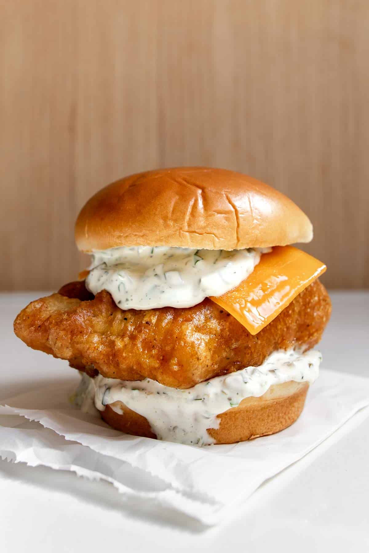 fried cod fish sandwich (homemade filet-o-fish) on a table.