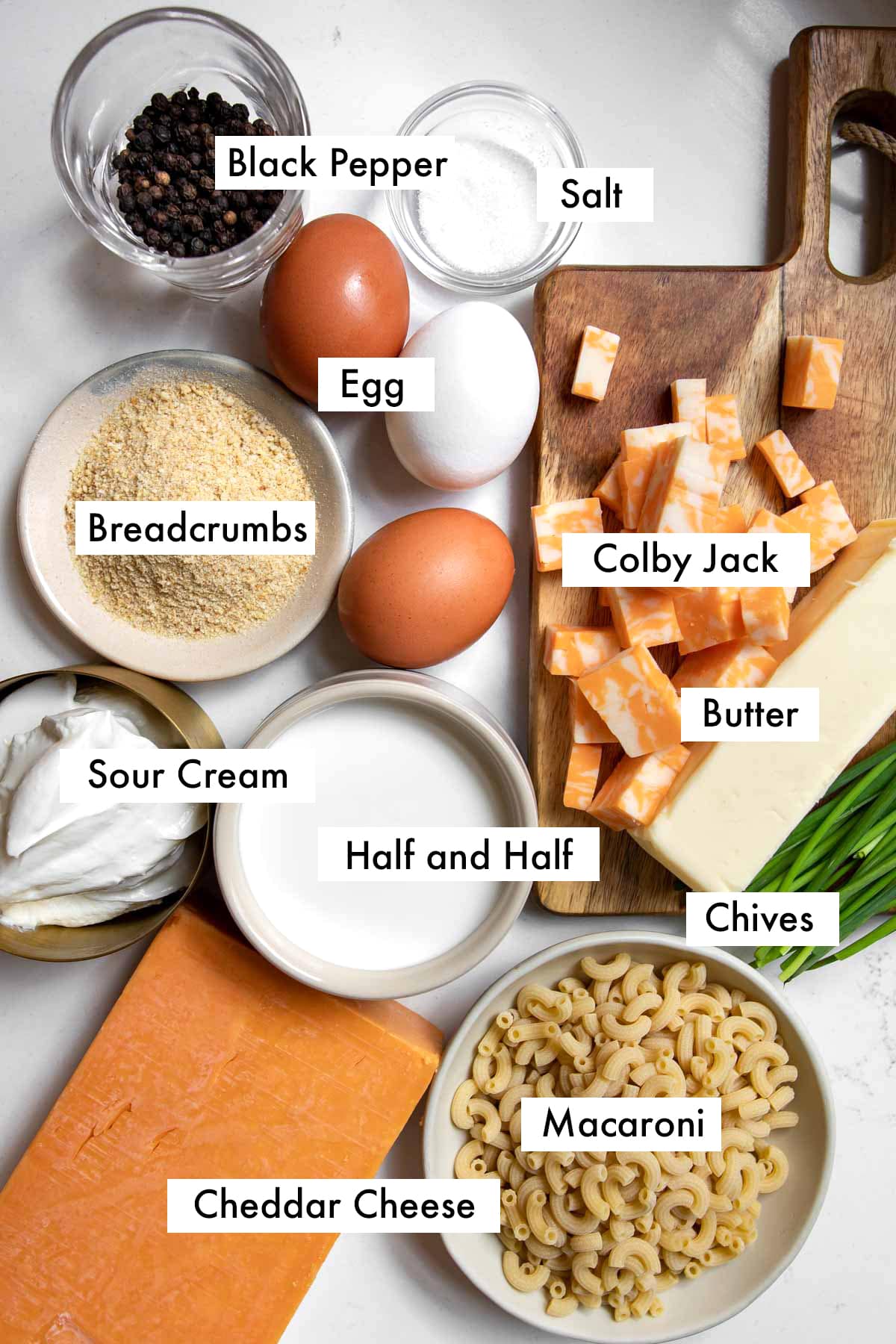 ingredients to make old fashioned baked macaroni and cheese with text graphics.