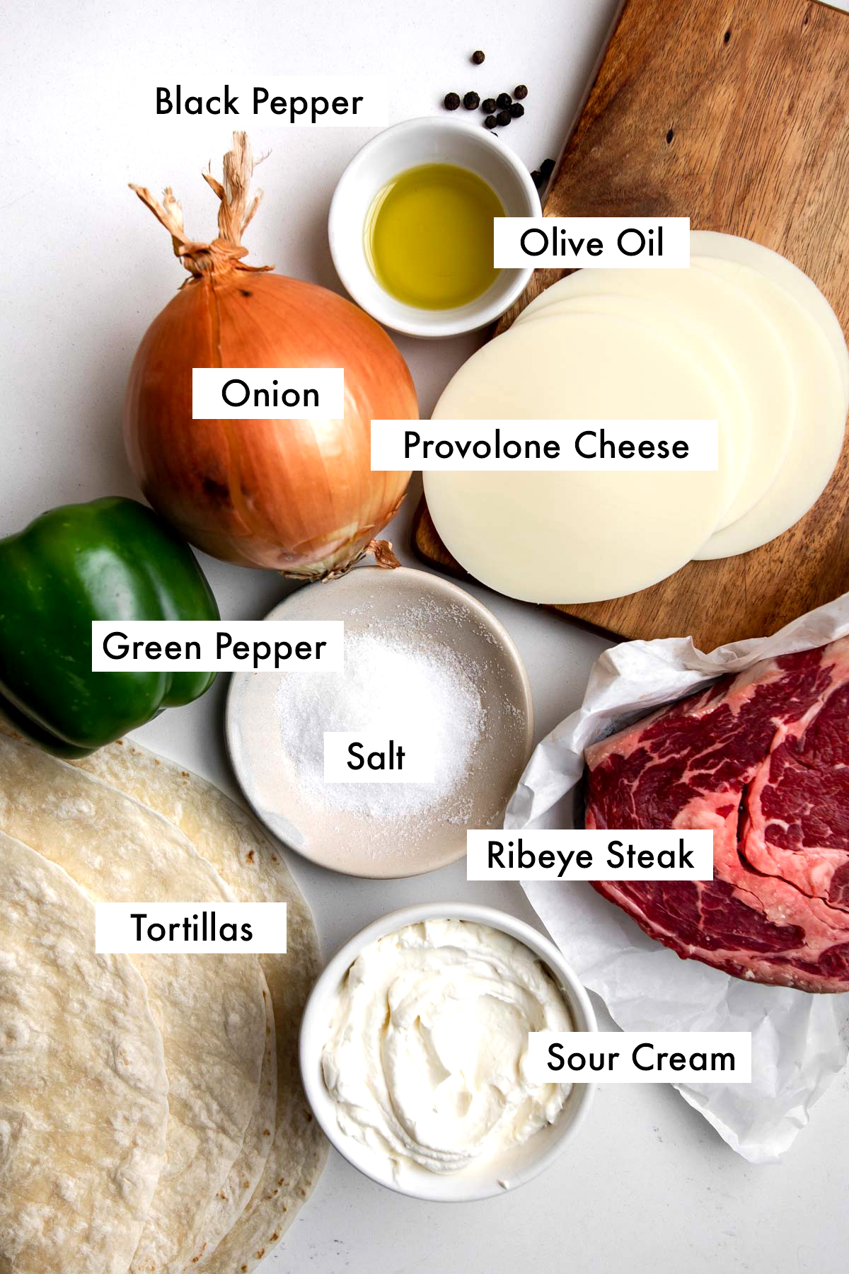 Ingredients to make Philly cheesesteak quesadillas labelled with text graphics.