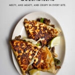 Philly cheesesteak quesadillas on a plate with lime wedges and text graphic of recipe title.