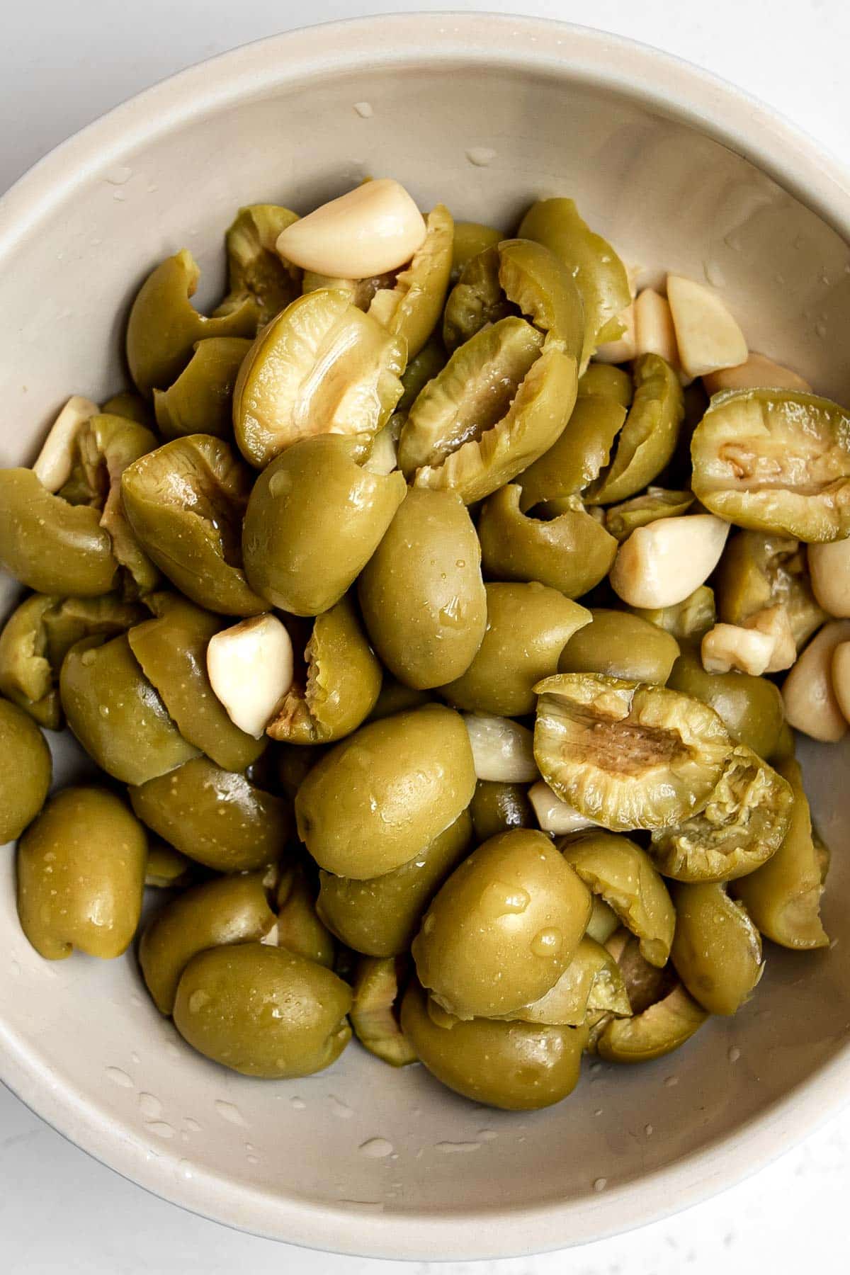 pitted garlic olives in a bowl.