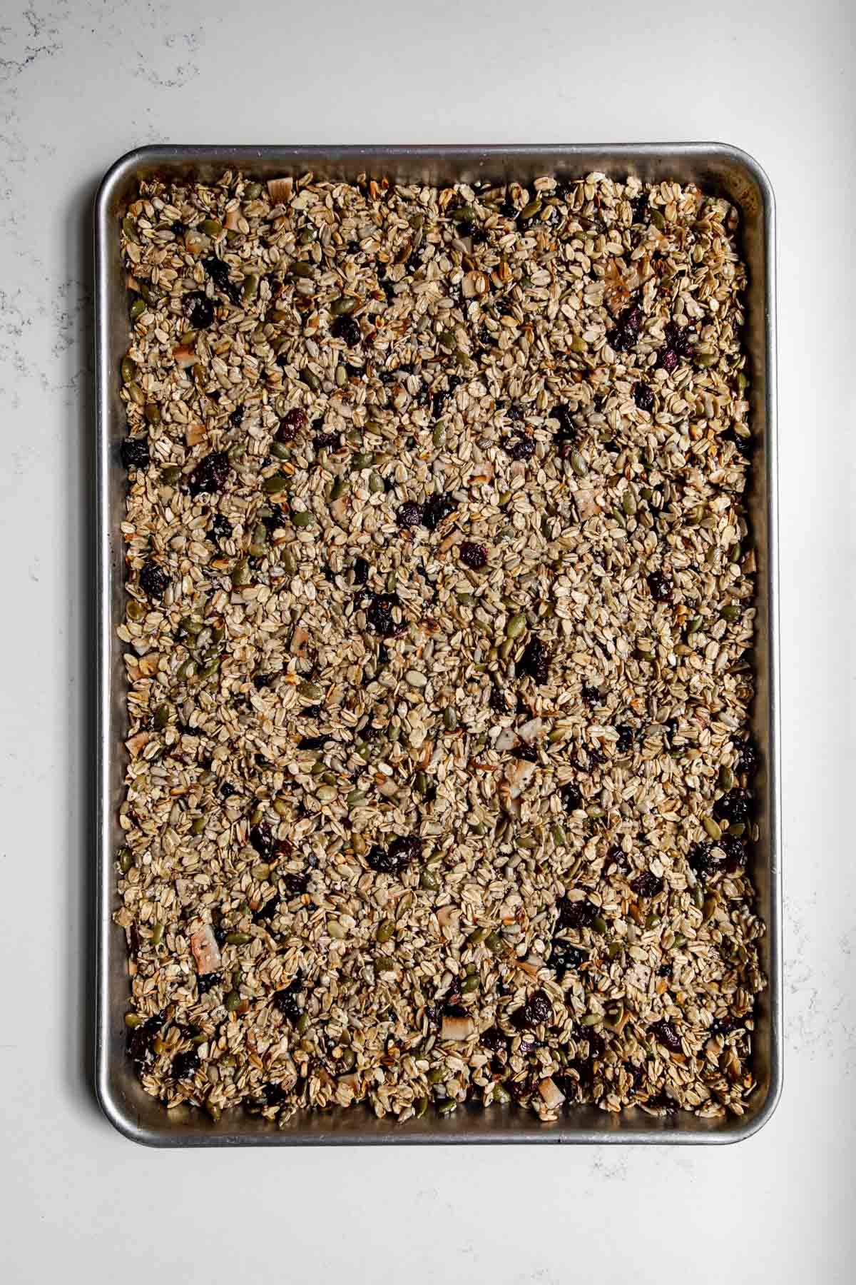 nut free granola spread out on a sheetpan.