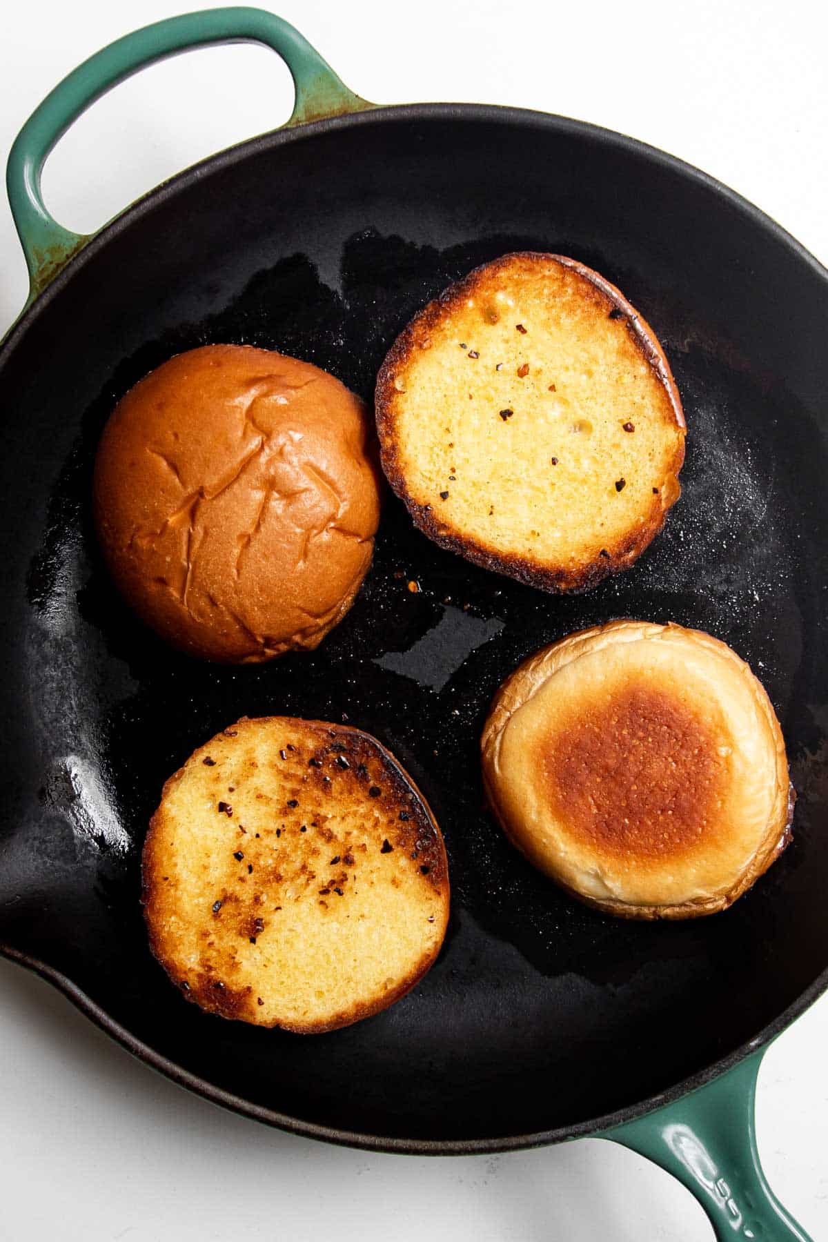 toasted brioche buns in a skillet.