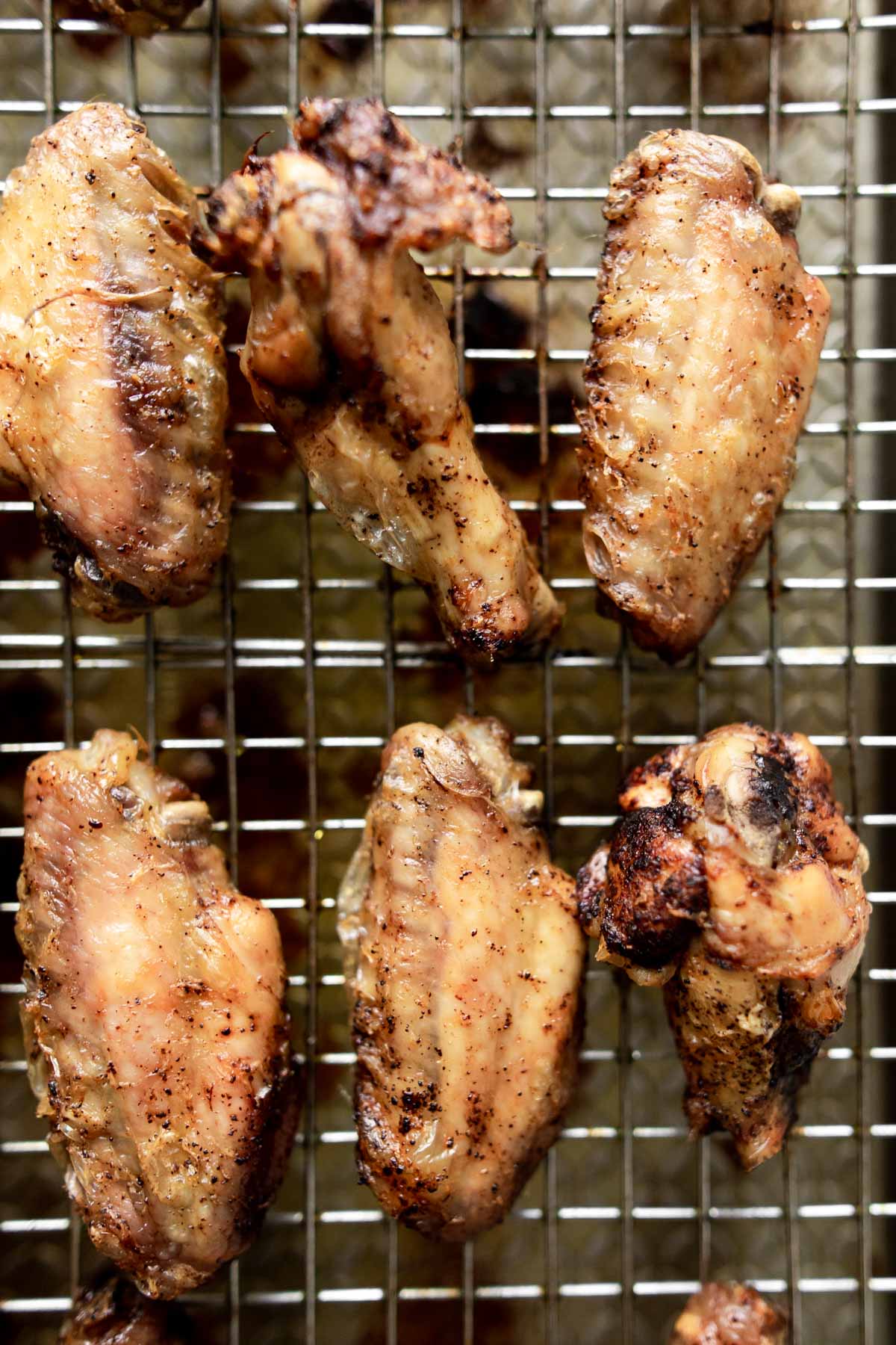 baked chicken wings on a wire cooling rack.