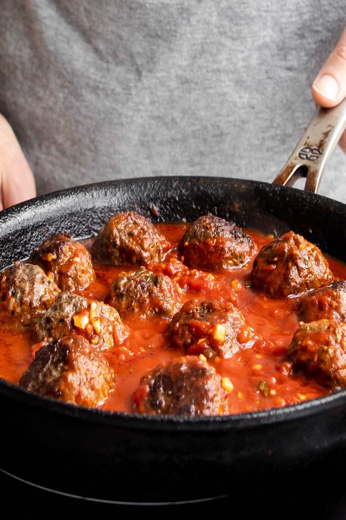 spicy meatballs with marinara sauce in a pan.