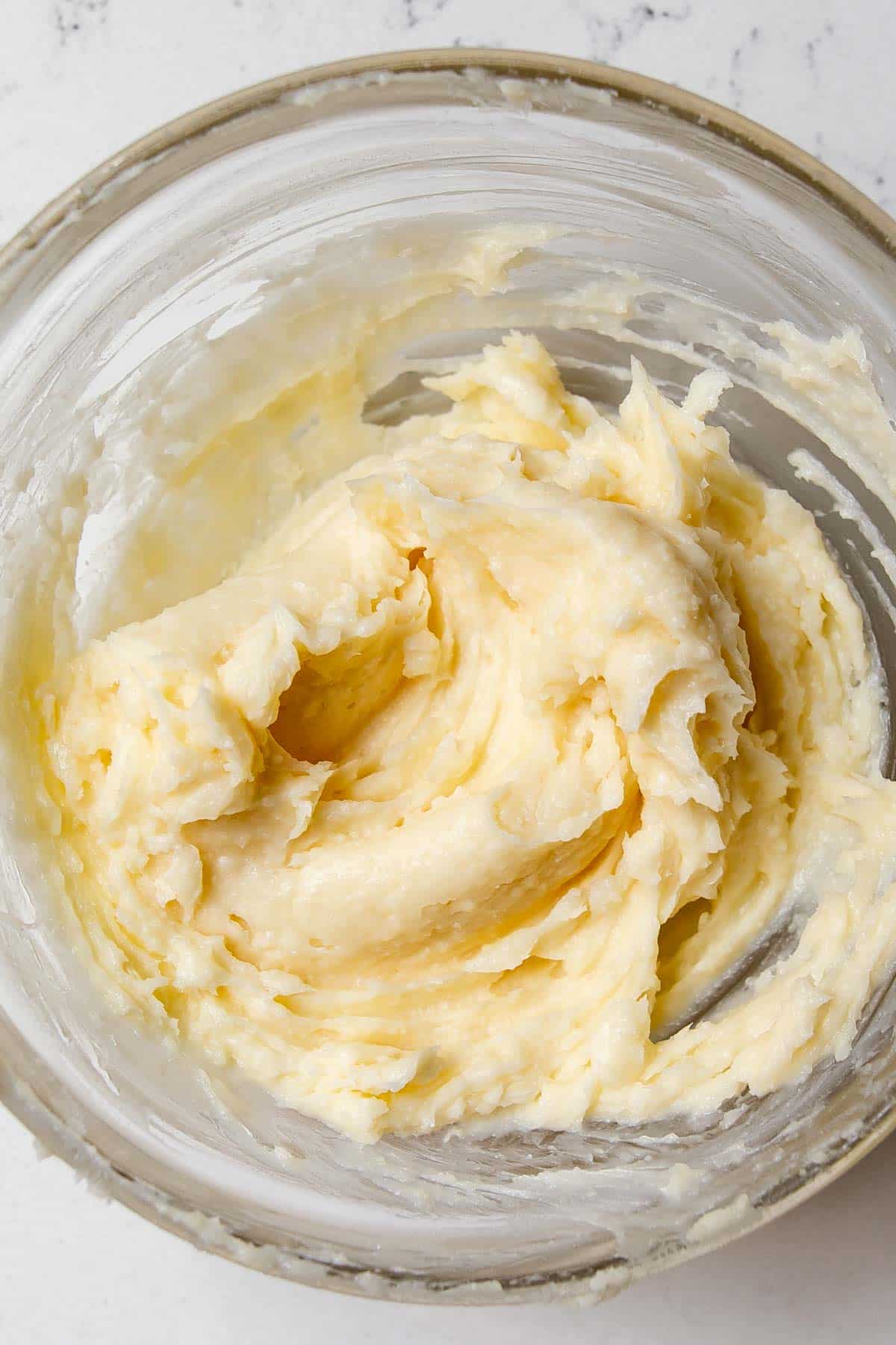 butter and parmesan cheese mixed together in a bowl.