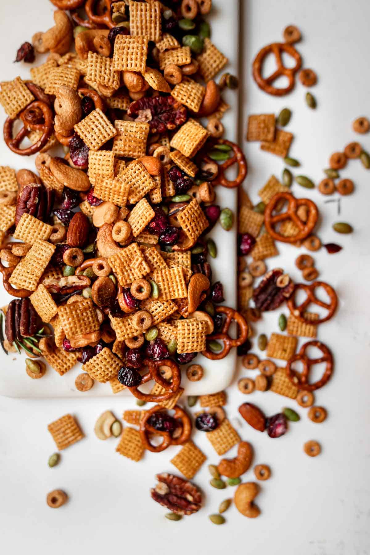 sweet and salty chex mix laid out on a marble cutting board.
